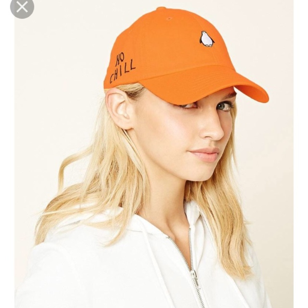 Lightweight orange baseball cap with penguin on it